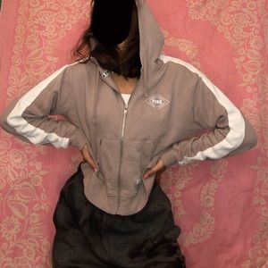 Pink cropped zip up hoodie.